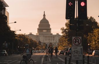 Washington D.C. street at sunset, the US Capitol dome in the distance